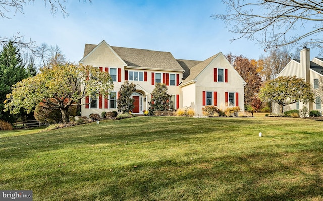 colonial home with a front lawn