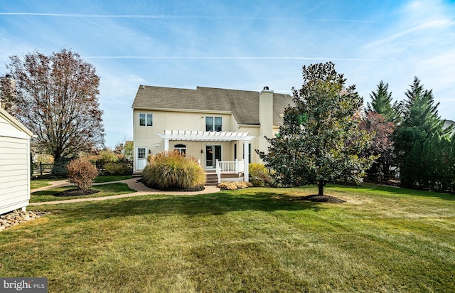 back of house with a lawn and a pergola