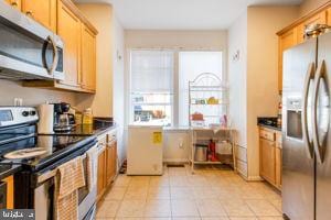 kitchen with stainless steel appliances and light tile patterned floors