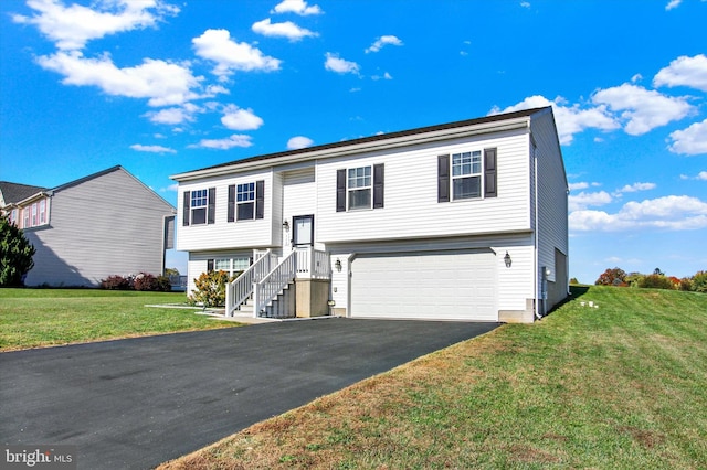 raised ranch with a front yard and a garage