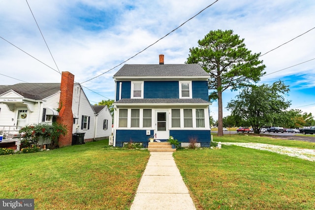 bungalow-style house featuring a front lawn