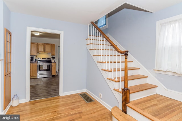 stairway featuring wood-type flooring