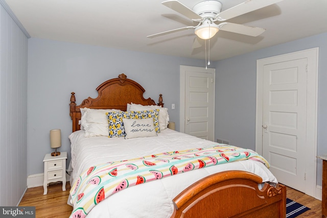 bedroom featuring light hardwood / wood-style flooring and ceiling fan