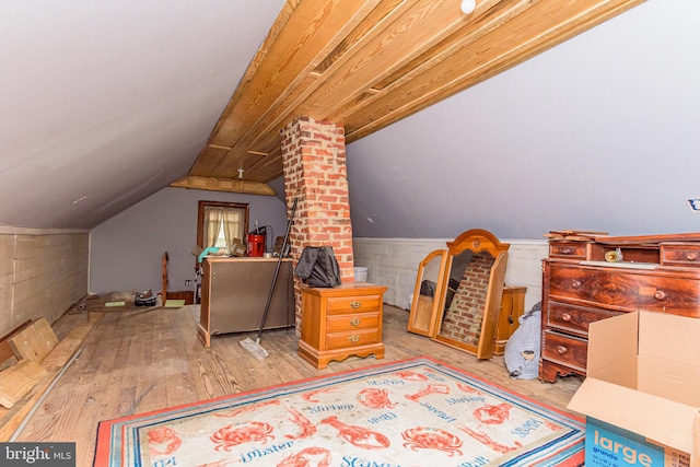 interior space featuring vaulted ceiling and light hardwood / wood-style floors