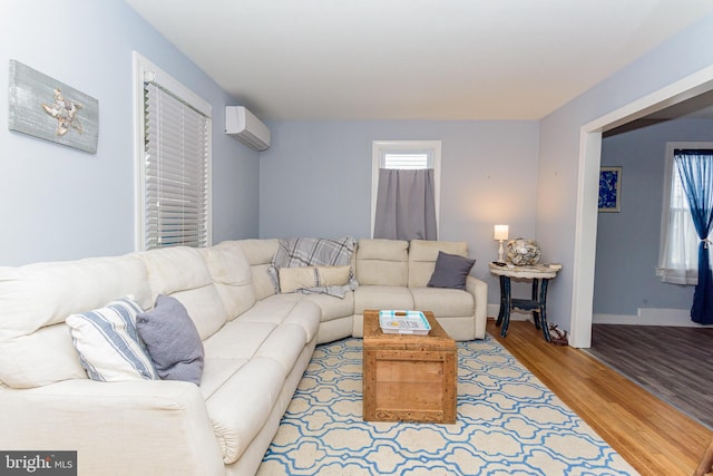 living room featuring light hardwood / wood-style floors and a wall mounted air conditioner