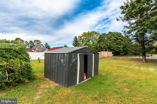 view of outbuilding featuring a yard