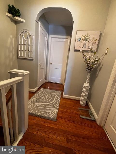 hall with dark wood-type flooring