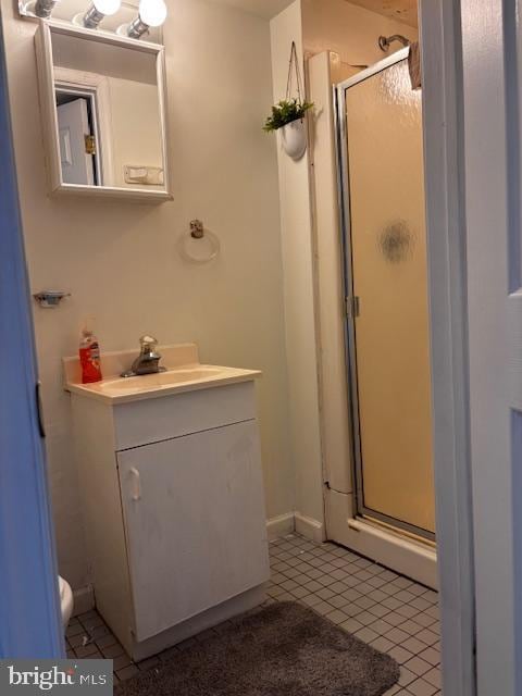 bathroom with vanity, tile patterned floors, and walk in shower