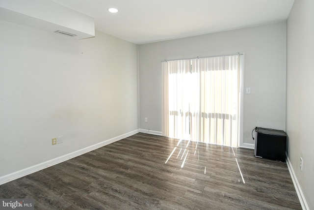 empty room featuring dark hardwood / wood-style flooring