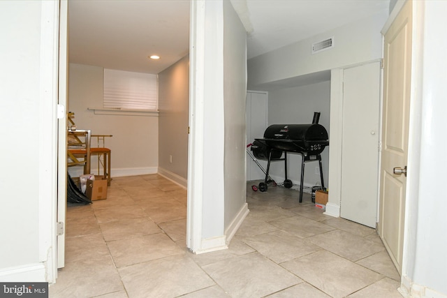 corridor with light tile patterned floors