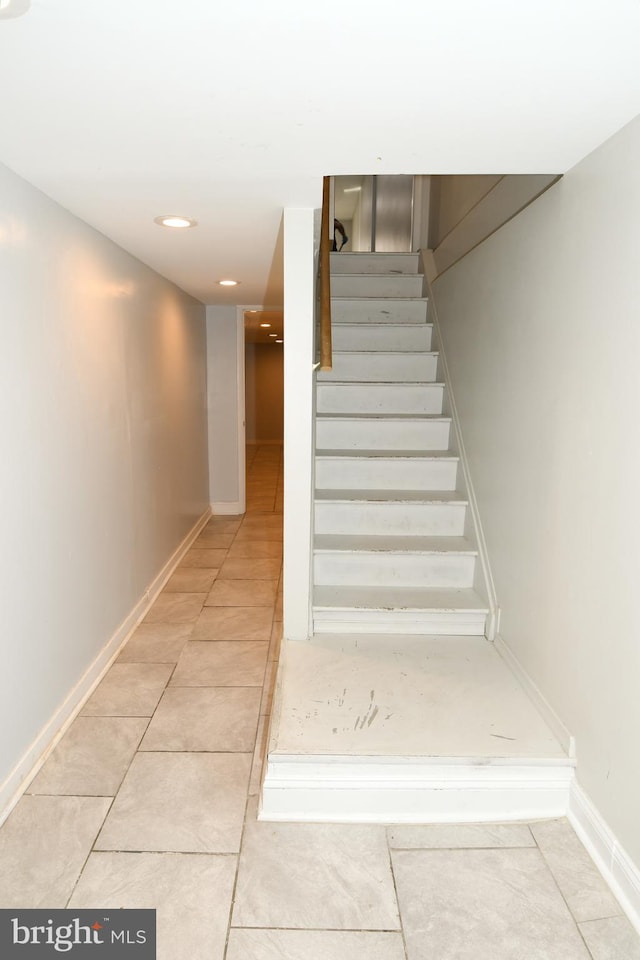 stairway featuring tile patterned floors