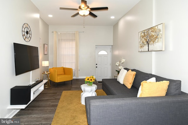 living room with dark hardwood / wood-style floors and ceiling fan