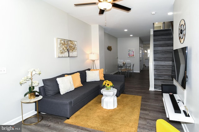 living room with ceiling fan and dark hardwood / wood-style flooring