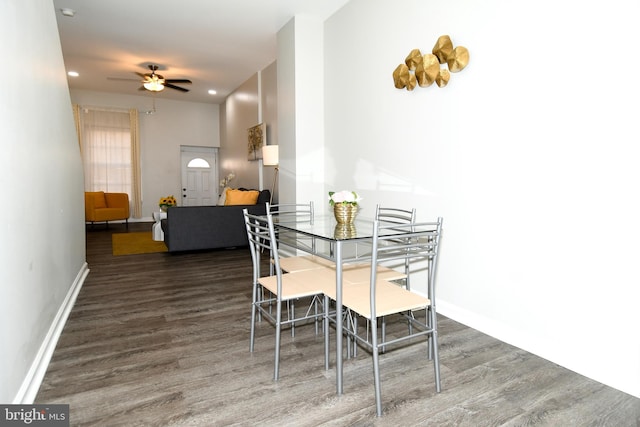 dining area with dark hardwood / wood-style floors and ceiling fan