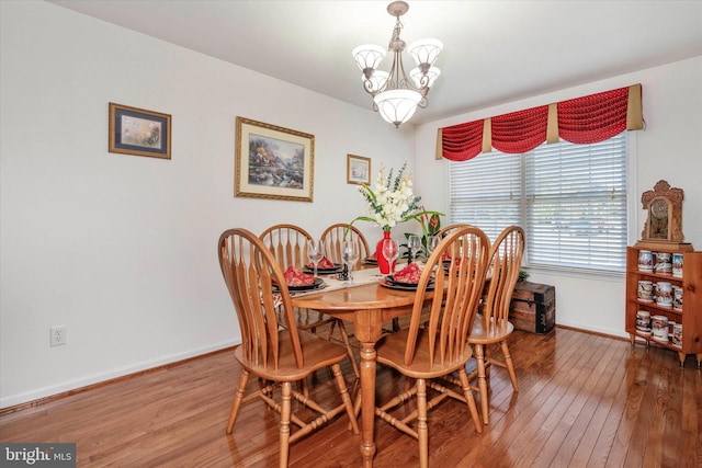 dining room with a notable chandelier and hardwood / wood-style flooring