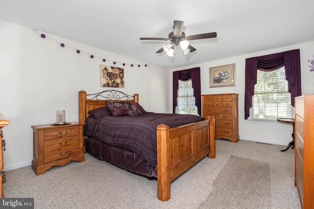 bedroom with ceiling fan and light colored carpet