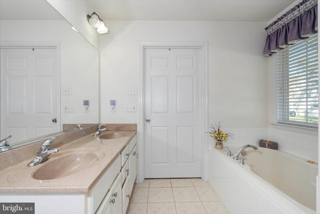 bathroom with vanity, tile patterned flooring, a relaxing tiled tub, and plenty of natural light