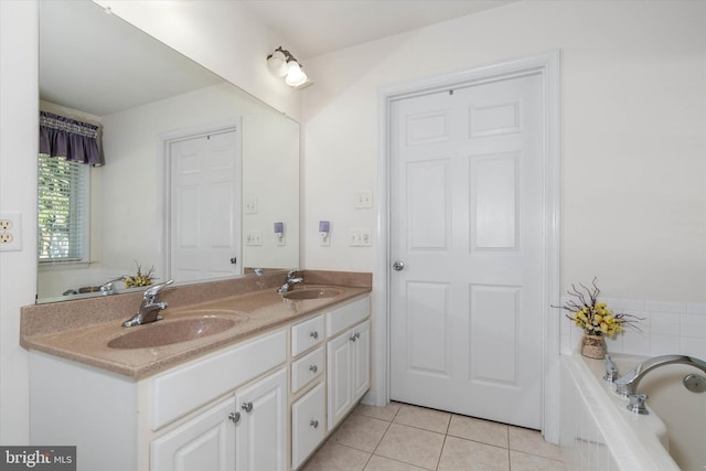 bathroom featuring vanity, a relaxing tiled tub, and tile patterned floors