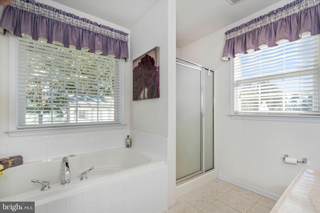 bathroom with tile patterned floors, independent shower and bath, and plenty of natural light