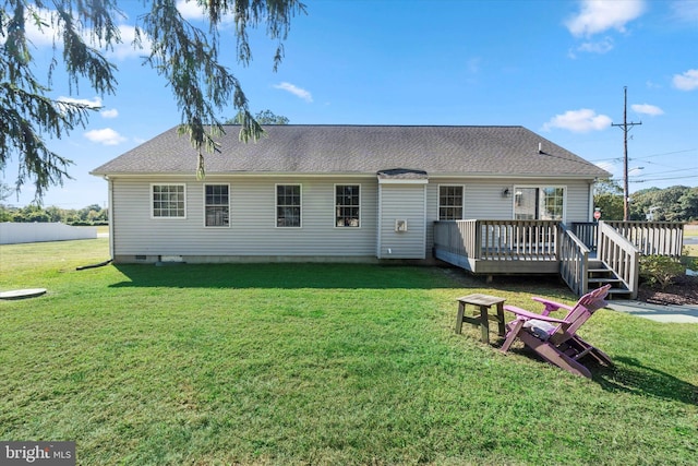 back of house featuring a yard and a deck