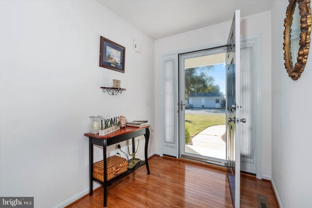 entryway with hardwood / wood-style floors and a healthy amount of sunlight