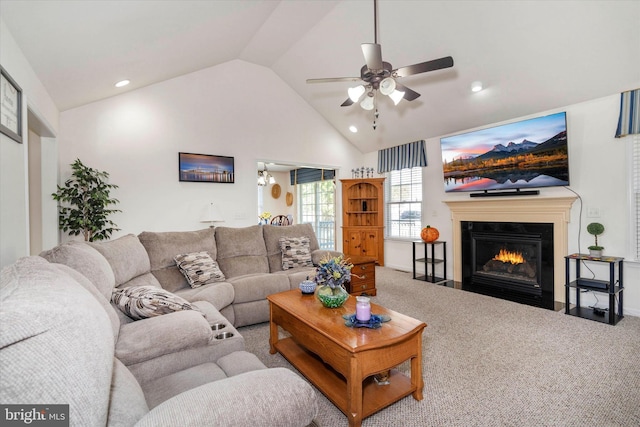 carpeted living room with high vaulted ceiling and ceiling fan