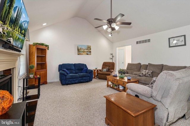 carpeted living room featuring vaulted ceiling and ceiling fan