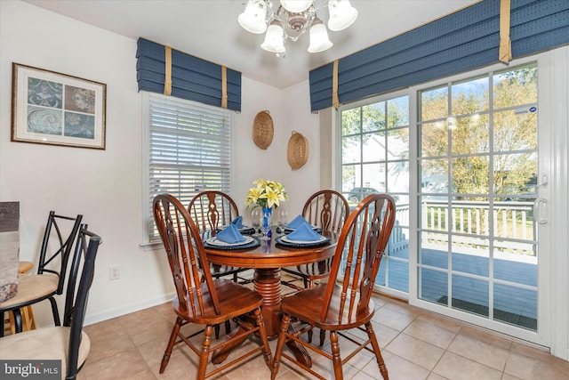 dining room featuring an inviting chandelier, a healthy amount of sunlight, and light tile patterned floors