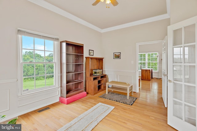 living area with a wealth of natural light and hardwood / wood-style flooring