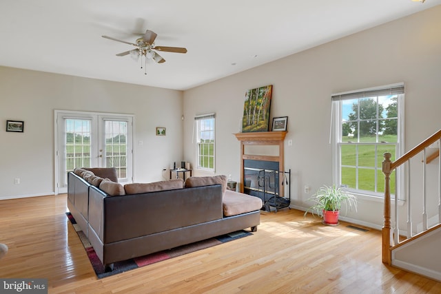 living room with french doors, ceiling fan, light hardwood / wood-style flooring, and plenty of natural light