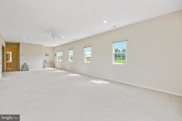 empty room featuring light carpet and ceiling fan