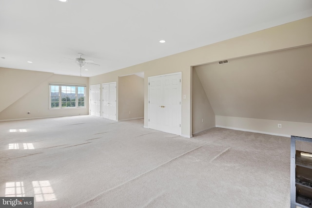 additional living space with ceiling fan, vaulted ceiling, and light colored carpet