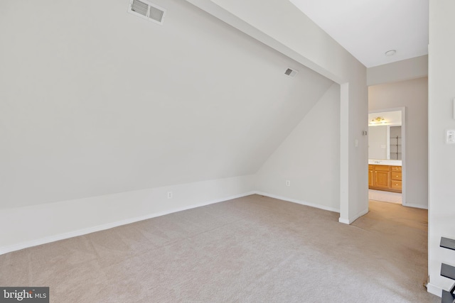 interior space with light carpet and lofted ceiling