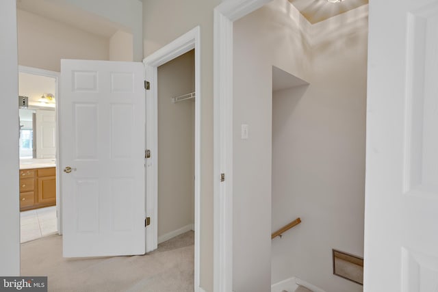 hallway with light colored carpet