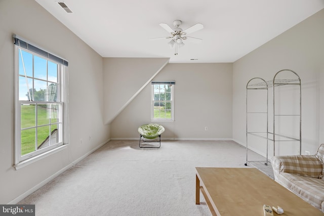 unfurnished room featuring ceiling fan, a healthy amount of sunlight, and light colored carpet