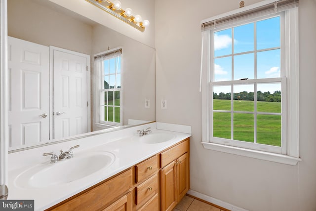 bathroom featuring vanity, a wealth of natural light, and tile patterned flooring