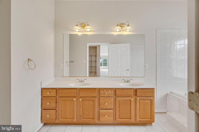 bathroom featuring vanity, a bath, and tile patterned flooring