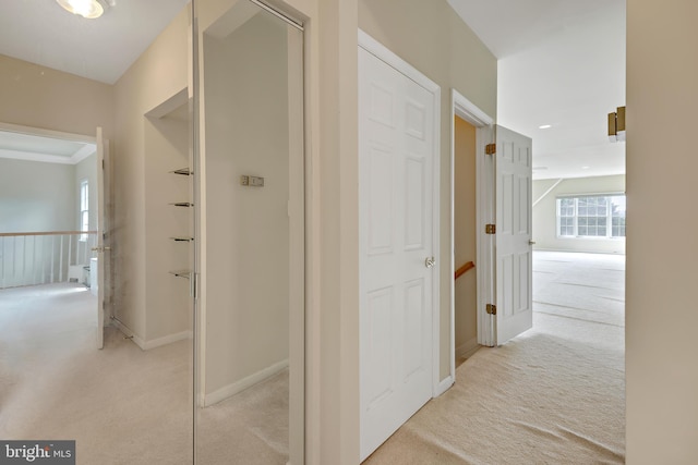 hall with light colored carpet