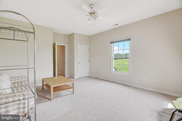 unfurnished room with light carpet and ceiling fan