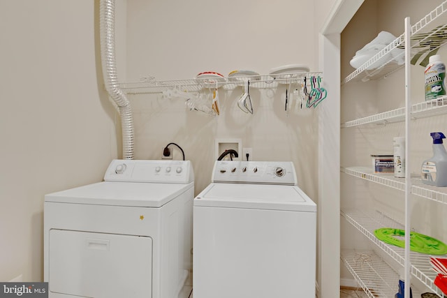 clothes washing area featuring washer and dryer