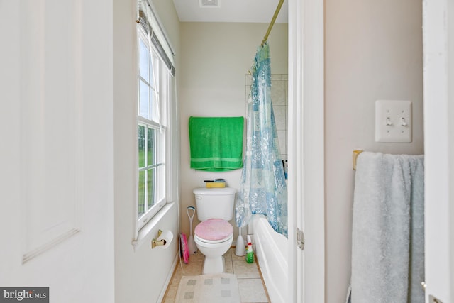 bathroom with toilet, shower / bathtub combination with curtain, and tile patterned flooring