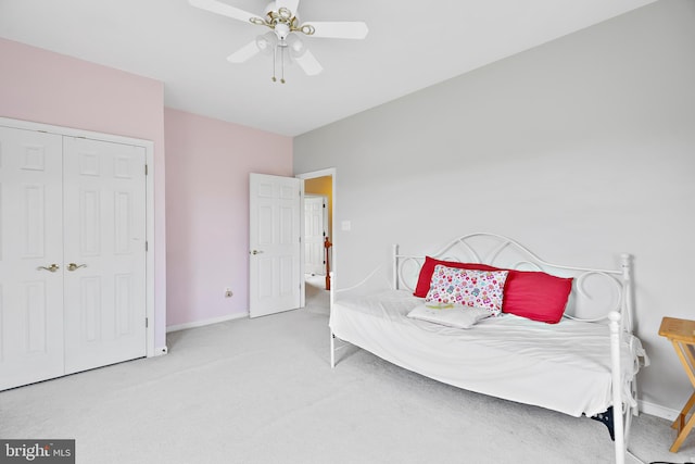 carpeted bedroom featuring a closet and ceiling fan