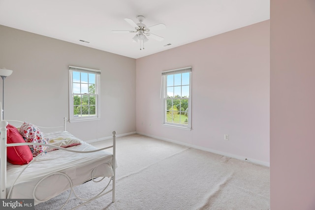 bedroom with light colored carpet and ceiling fan