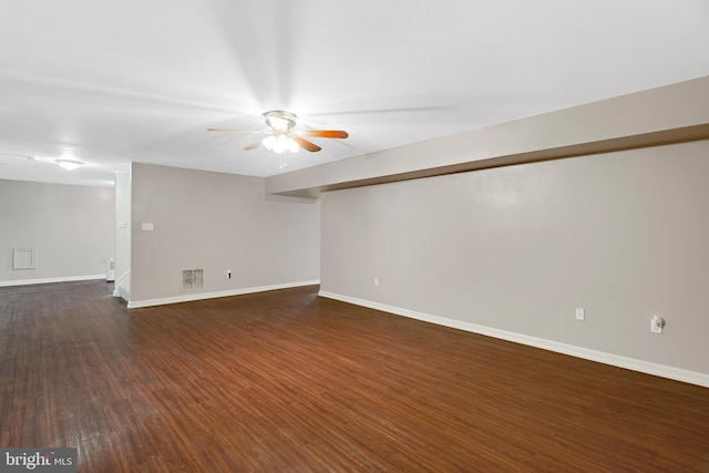 spare room featuring dark hardwood / wood-style floors and ceiling fan