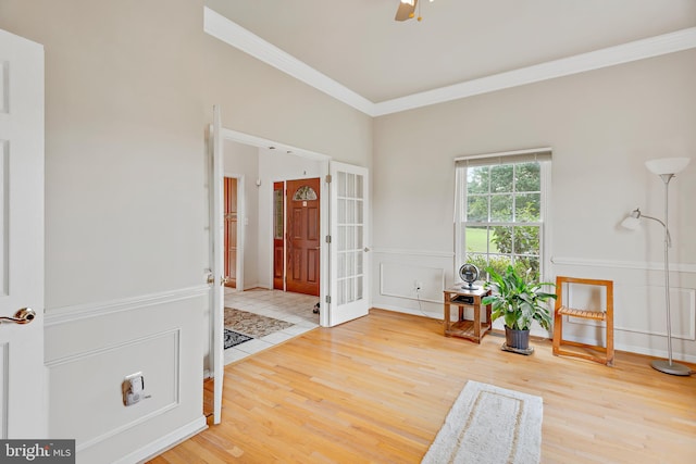 living area featuring crown molding and hardwood / wood-style flooring