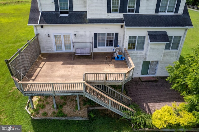 rear view of property with a yard and a deck