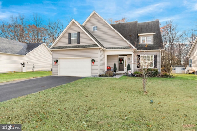 view of front of home with a garage and a front lawn