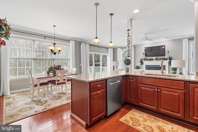 kitchen featuring a wealth of natural light, sink, hardwood / wood-style floors, and decorative light fixtures