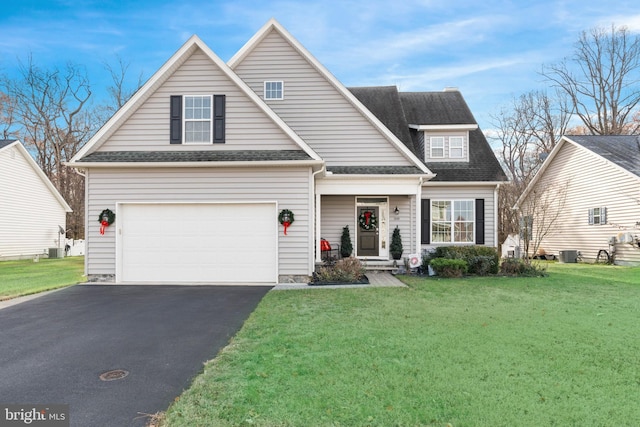 view of front property with central AC, a front lawn, and a garage