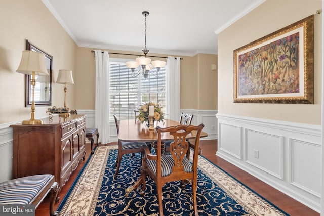 dining room featuring a chandelier, ornamental molding, a wealth of natural light, and dark wood-type flooring